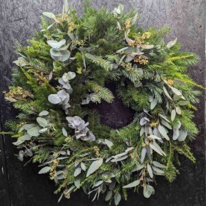 Natural pine and eucalyptus Christmas door wreath with mixed seasonal greenery