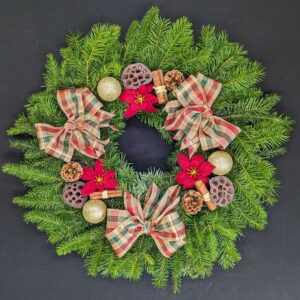Pine Christmas door wreath with heritage tartan bows, gold baubles, poinsettia, pinecones and cinnamon