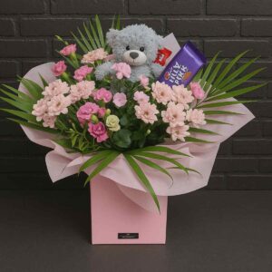 Flower bouquet with teddy bear and chocolates