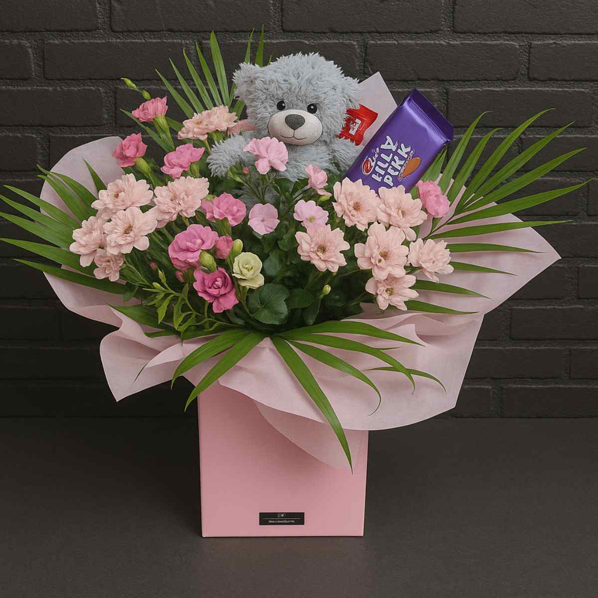 Flower bouquet with teddy bear and chocolates