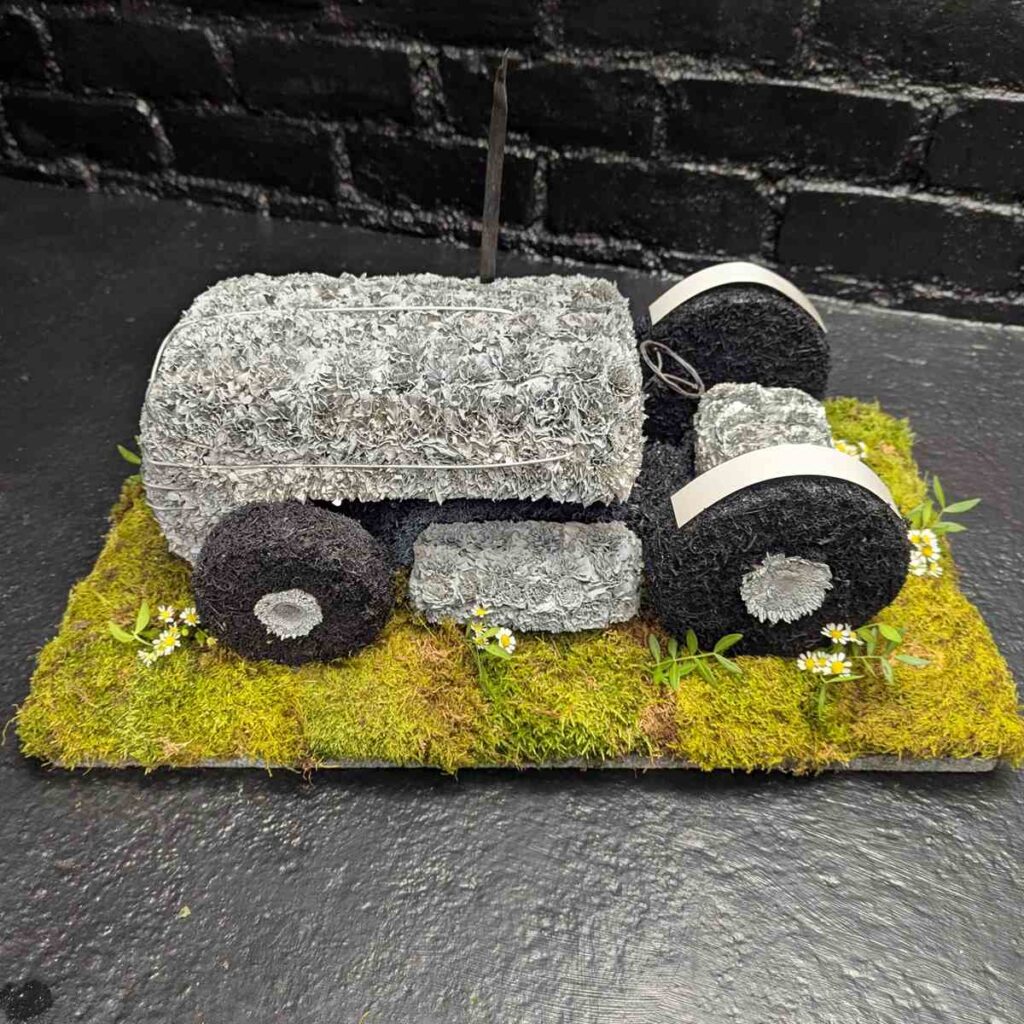 What Flower Arrangements are Suitable for a Male Funeral? Grey Fergie tractor floral tribute for funerals – close-up