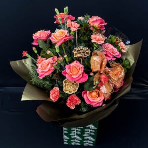 Orange and pink festive flower bouquet with greenery