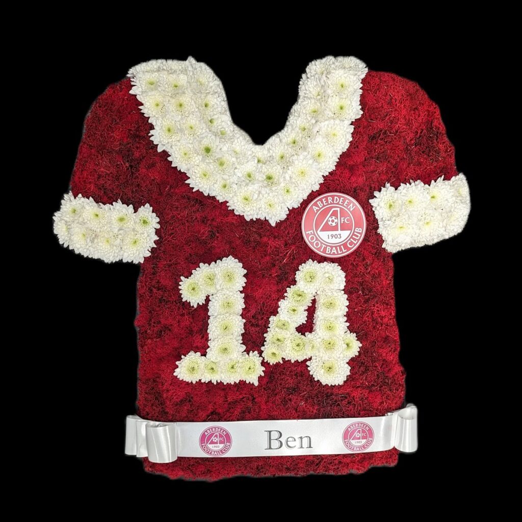 What Flower Arrangements are Suitable for a Male Funeral? Floral tribute in the shape of an Aberdeen football shirt
