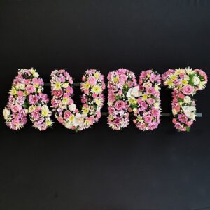 Funeral tribute flowers spelling 'Aunt'