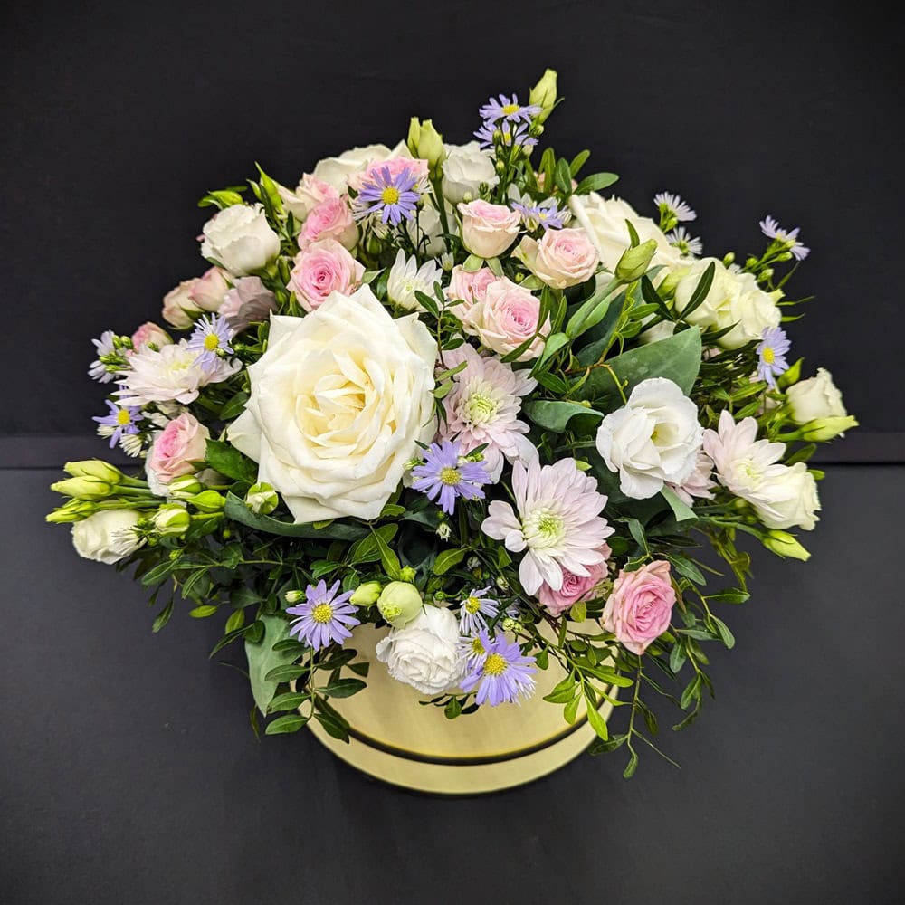 pastel flower arrangement in a hat box