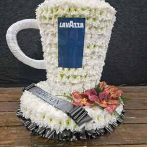 Funeral coffee cup tribute with white flowers