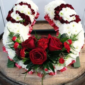 Funeral horse shoe with red roses and white chrysanthemums