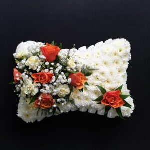 Orange rose funeral pillow tribute with white chrysanthemum base, hand-made in our Aberdeen flower shop. Free delivery to local funeral directors or the family home.
