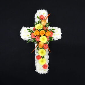 Orange and yellow funeral cross with white chrysanthemum base, roses, gerberas and carnations