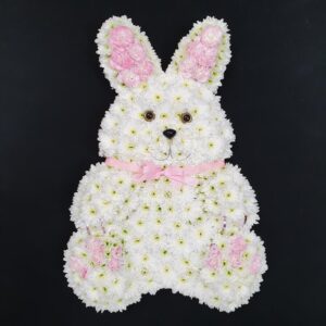 Bunny rabbit funeral tribute made from white chrysanthemums with pink rose ears, paws and ribbon bow from Anastasia Florists Aberdeen.