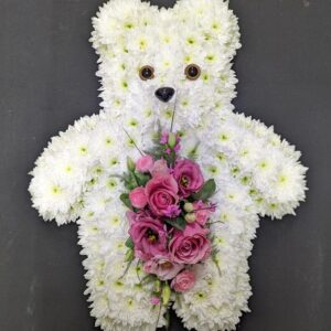 White teddy bear funeral tribute made from chrysanthemums holding a pink rose and lisianthus posy from Anastasia Florists Aberdeen.