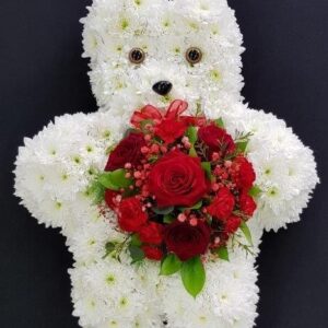 White teddy bear funeral tribute made from chrysanthemums holding a red rose and carnation posy from Anastasia Florists Aberdeen.
