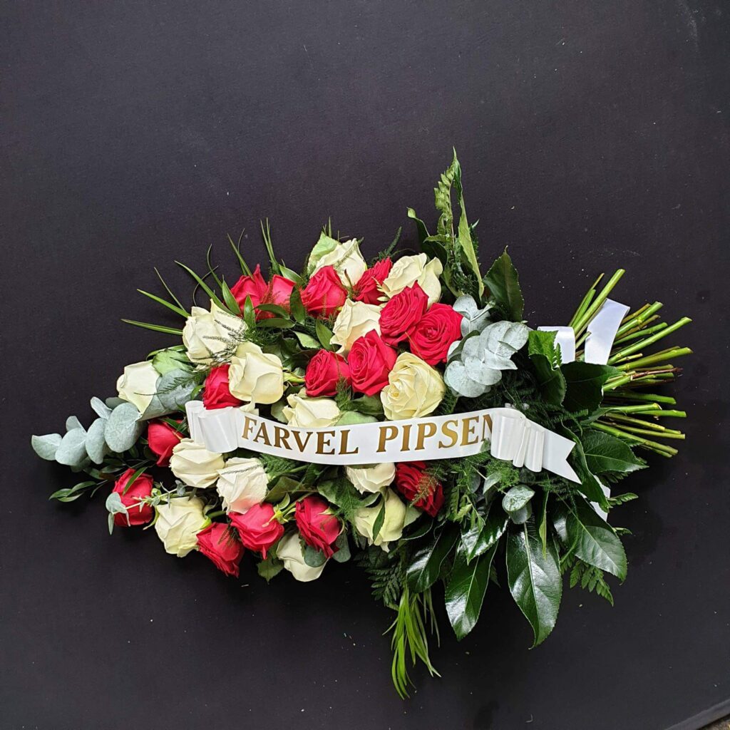 Funeral Flower Tributes Explained: Coffin Sprays, Wreaths, Hearts, Posies & More Red and white rose tied sheaf funeral spray with personalised ribbon and greenery