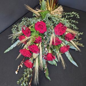 Rustic red rose and wheat sheaf funeral spray with eucalyptus and foliage