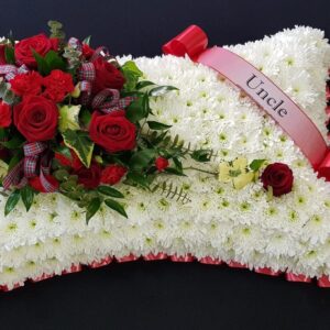Uncle red rose funeral pillow tribute with white chrysanthemum base and red ribbon edge