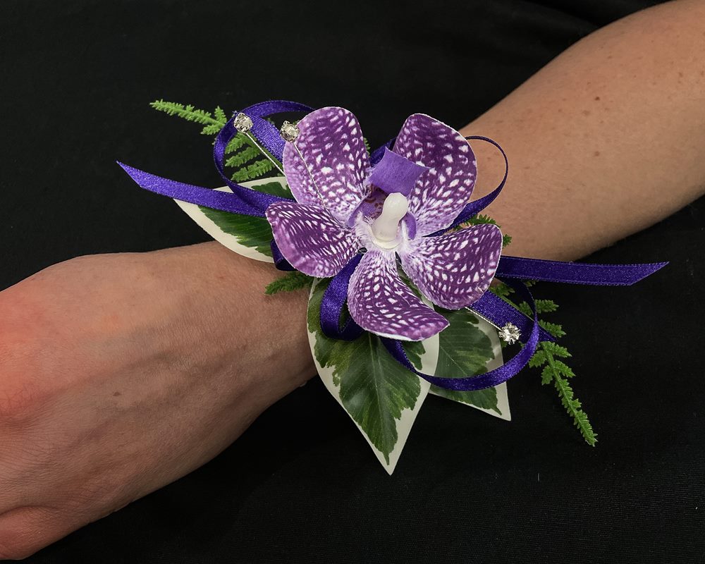 Wrist Corsage Wedding Flower (Purple) Purple orchid wrist corsage on arm