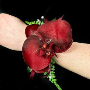 Red wrist corsage with lush blooms for weddings