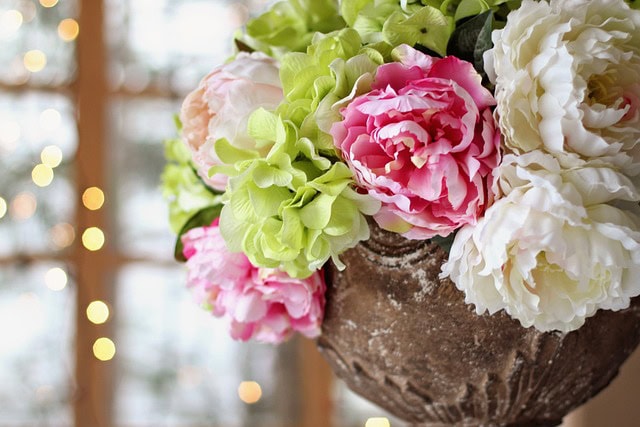 Flowers in a brown vase at a wedding