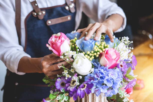 An florist arranging flowers at home in Scotland