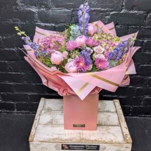 Luxury pink hydrangea and purple delphinium flower box arrangement by Anastasia Florists.