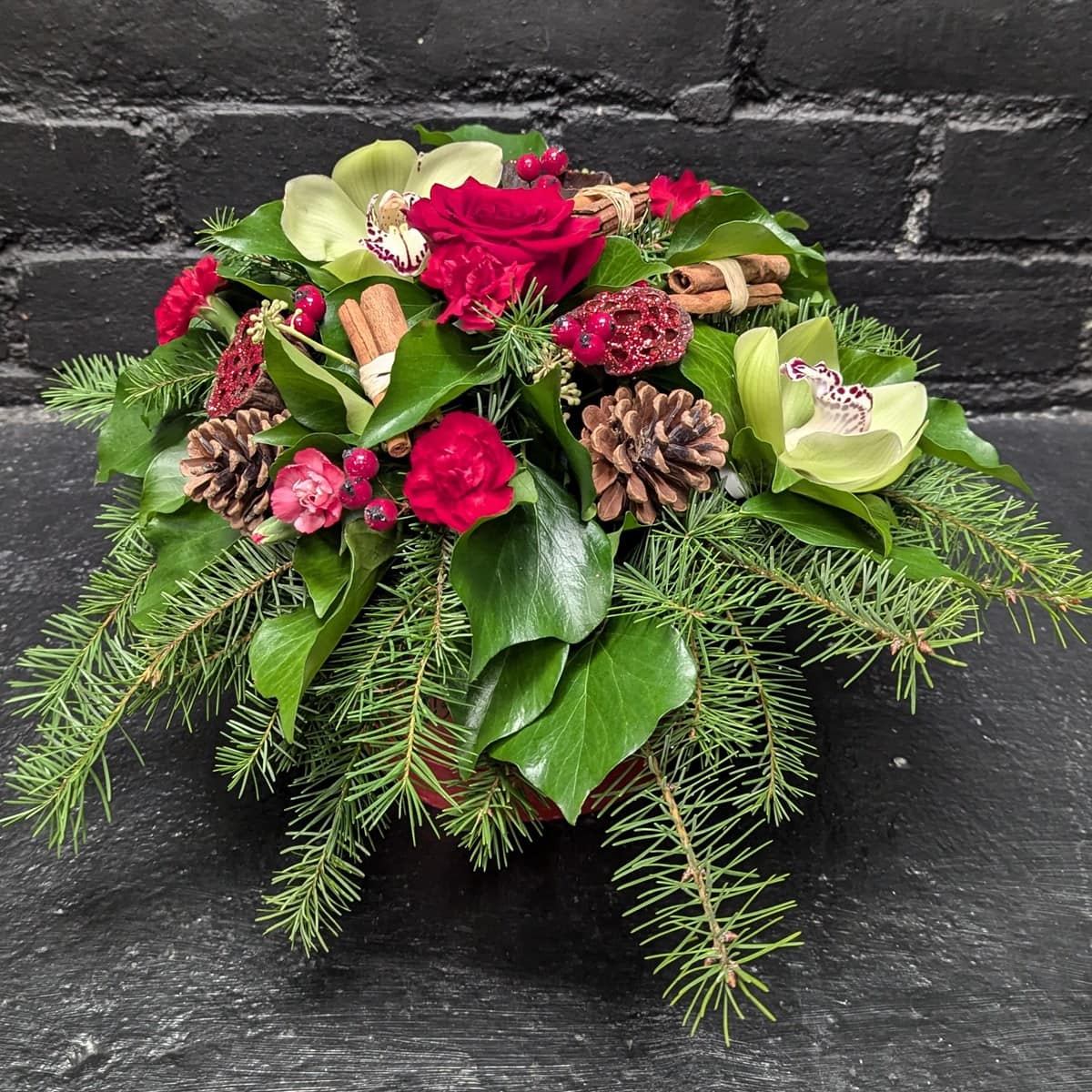 Christmas Hat Box 4 Festive flower arrangement in Christmas hat box. – angle view