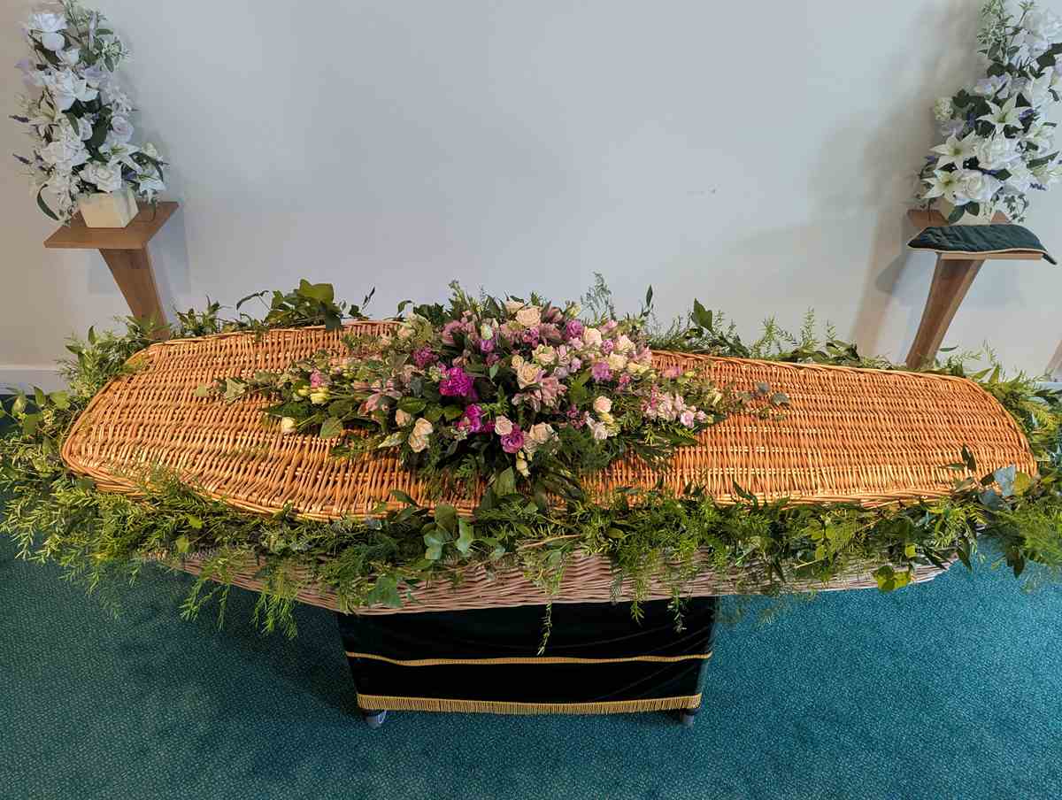 Funeral Casket Spray Garland 3 Funeral casket garland with flowers and greenery – side view
