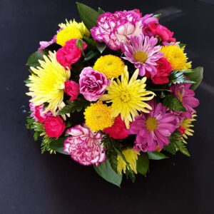 Pink and yellow funeral posy with greenery