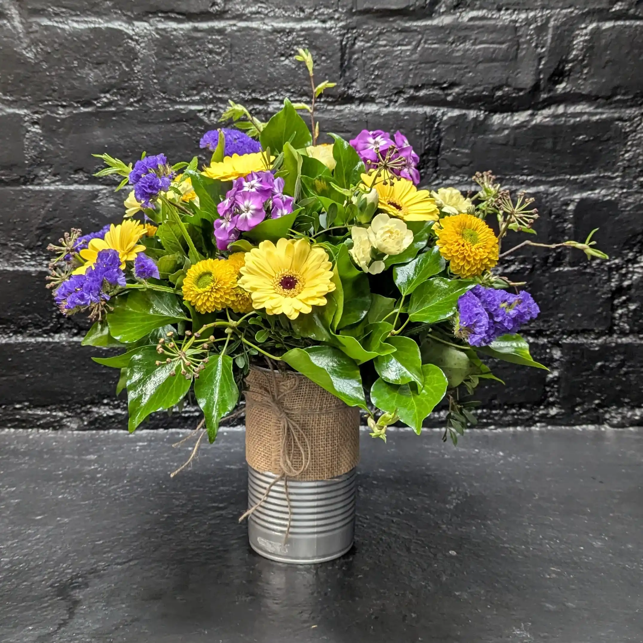 Tin of Seasonal 2025 1 Colourful arrangement of seasonal flowers in a tin – close-up
