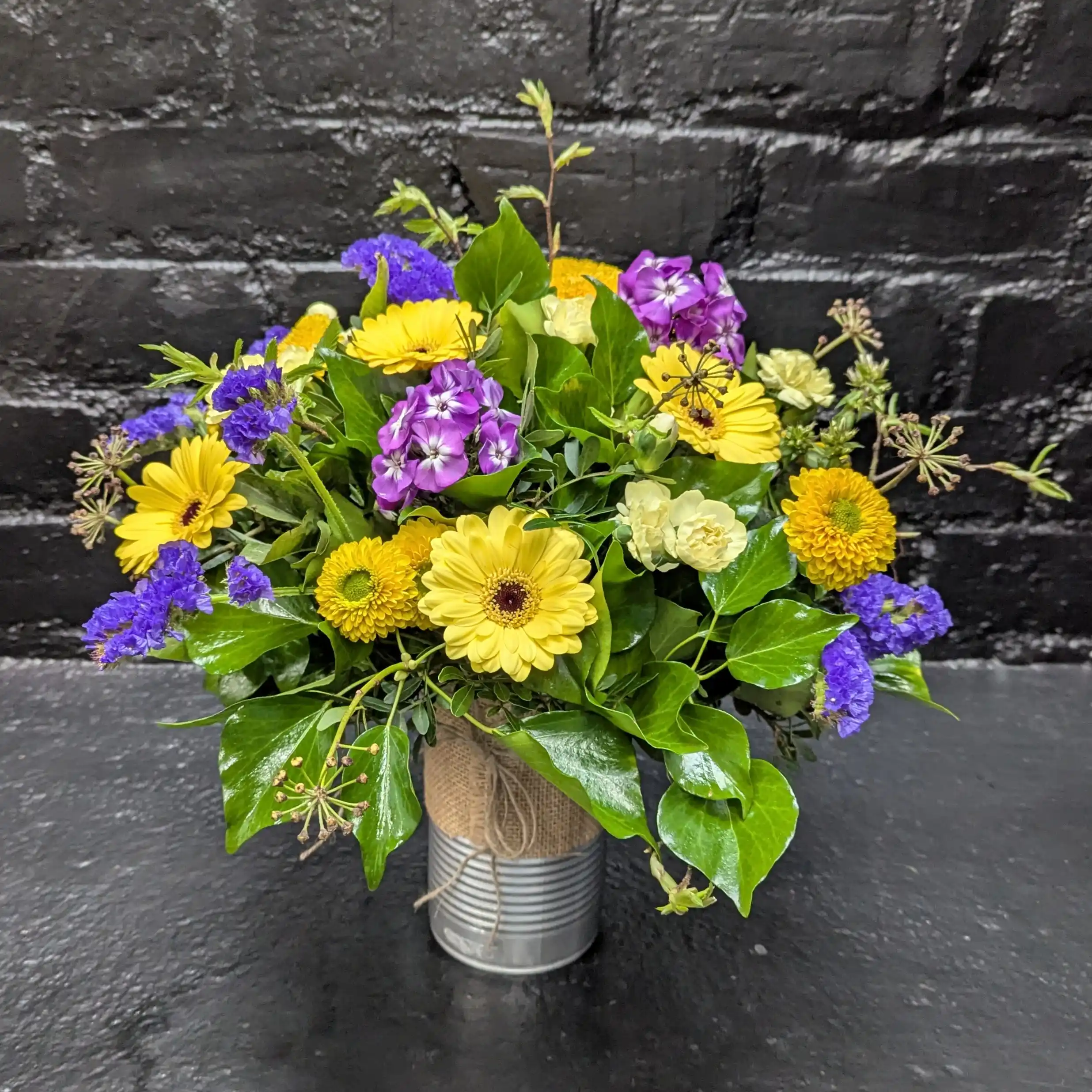 Tin of Seasonal 2025 2 Colourful arrangement of seasonal flowers in a tin.