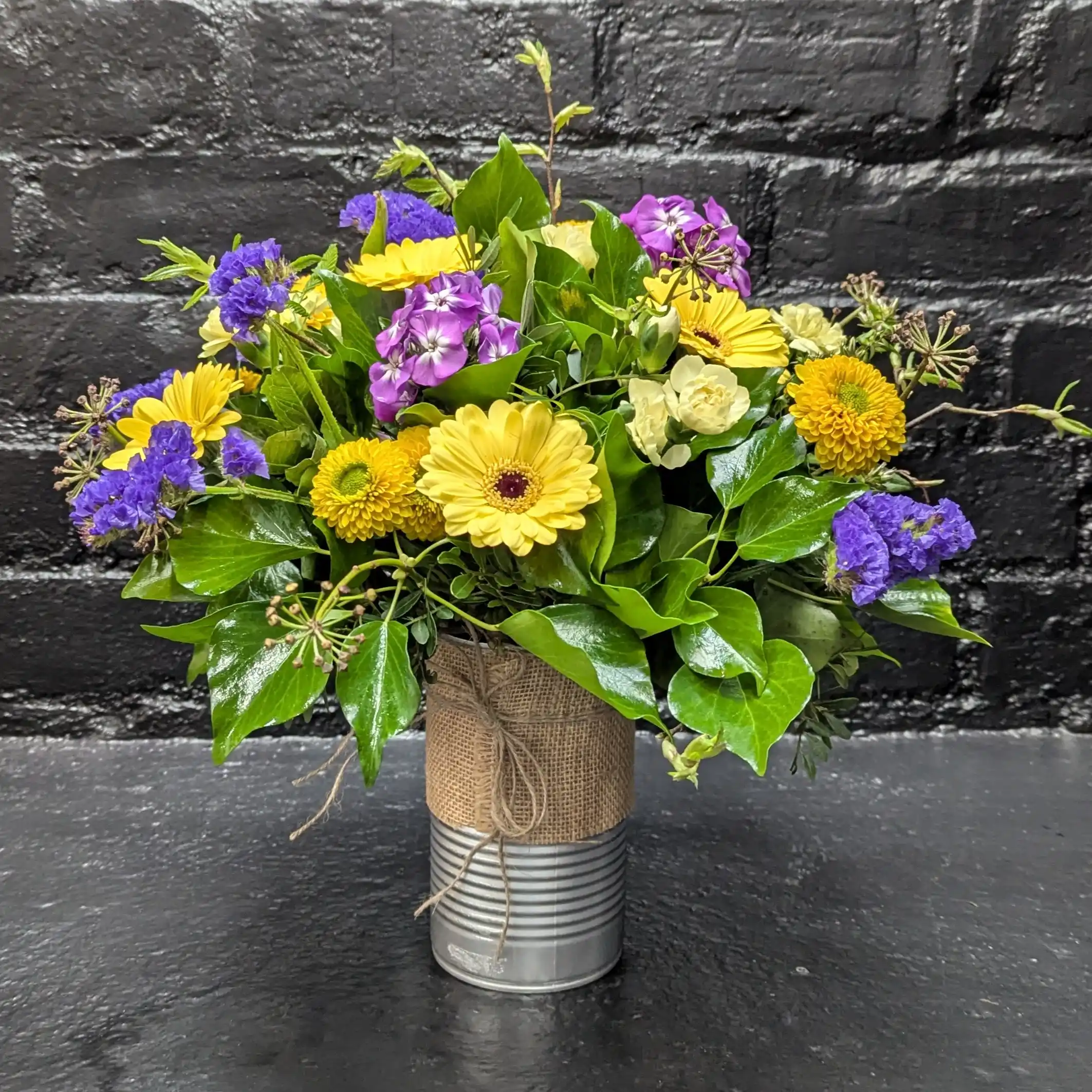 Tin of Seasonal 2025 Colourful arrangement of seasonal flowers in a tin – side view