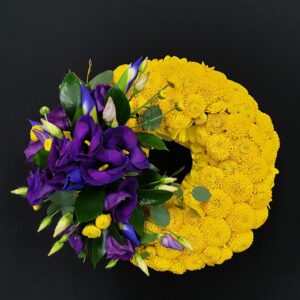 Vibrant iris and chrysanthemum funeral wreath