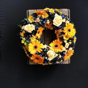 Funeral wreath with orange gerberas and white roses