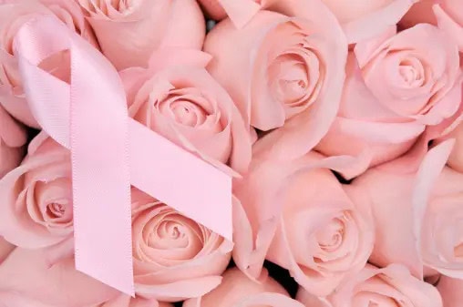 Breast Cancer Awareness Ribbon on a bed of light pink Roses.