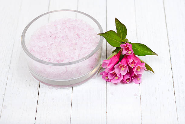 silica gel method for flowers Pink blooms next to a jar filled with Silica Gel