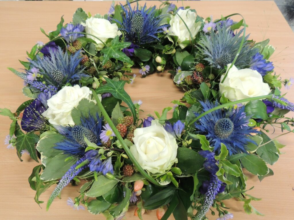 A blue funeral wreath on a table
