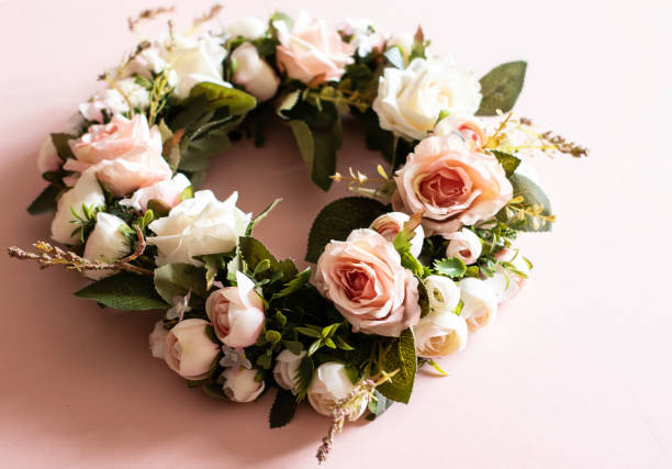 A funeral wreath with a pink background